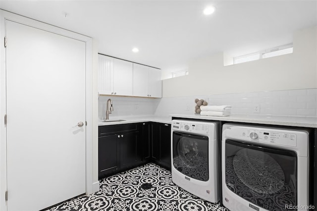 laundry area featuring sink, cabinets, independent washer and dryer, and light tile patterned flooring