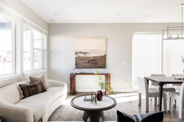 living room featuring a notable chandelier and hardwood / wood-style flooring