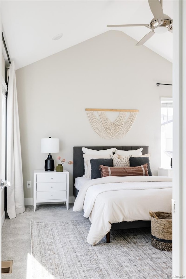 carpeted bedroom featuring lofted ceiling and ceiling fan