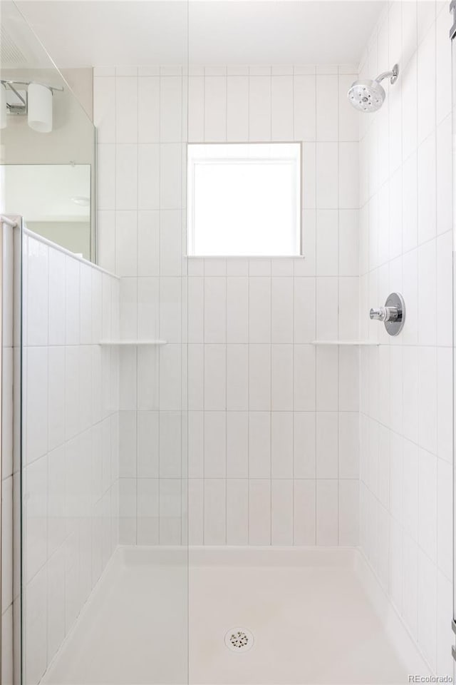 bathroom with a tile shower