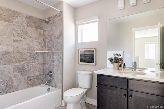 full bathroom with vanity, tiled shower / bath combo, and toilet