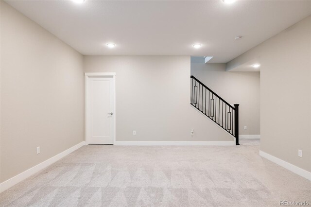 basement featuring light colored carpet