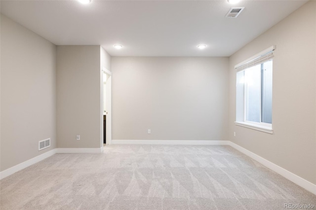 empty room featuring light colored carpet