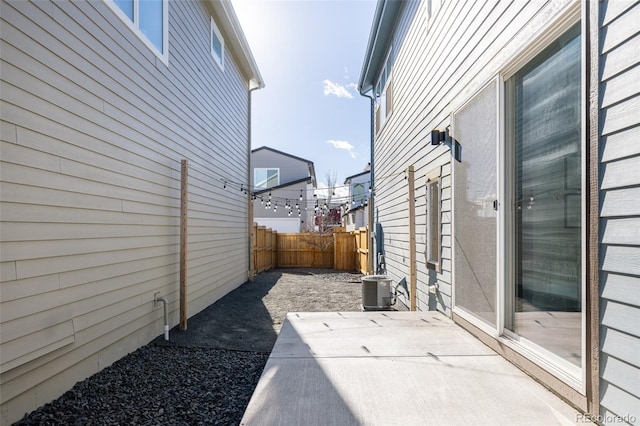 view of side of home with cooling unit and a patio area