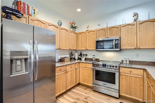 kitchen featuring appliances with stainless steel finishes, light wood-type flooring, and light brown cabinetry