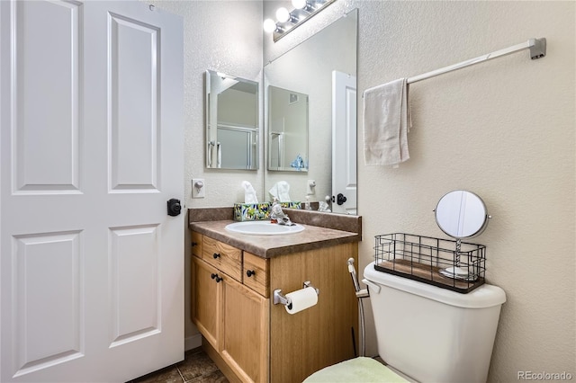 bathroom with tile patterned floors, vanity, and toilet