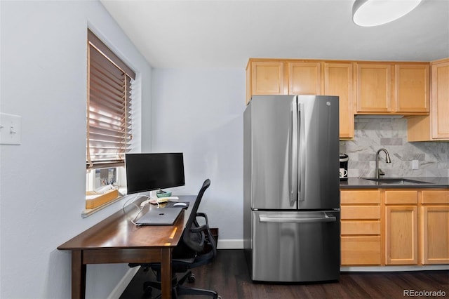 kitchen with backsplash, stainless steel refrigerator, sink, and dark hardwood / wood-style floors