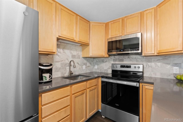 kitchen with backsplash, light brown cabinets, sink, and appliances with stainless steel finishes