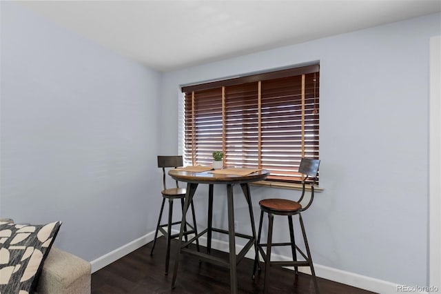 dining space with dark wood-type flooring