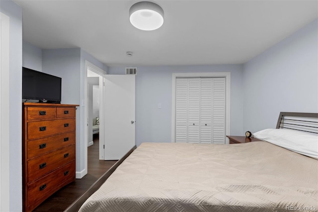 bedroom featuring dark hardwood / wood-style floors and a closet