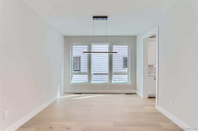 unfurnished dining area featuring light hardwood / wood-style floors