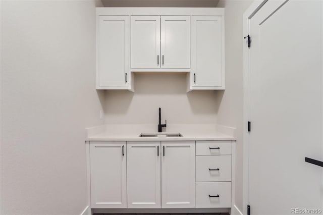 kitchen featuring sink and white cabinets