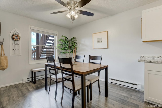 401 Forest Edge Rd Unit B1, Woodland Park, CO 80863 - dining area featuring baseboard heating, wood finished floors, ceiling fan, a textured ceiling, and baseboards