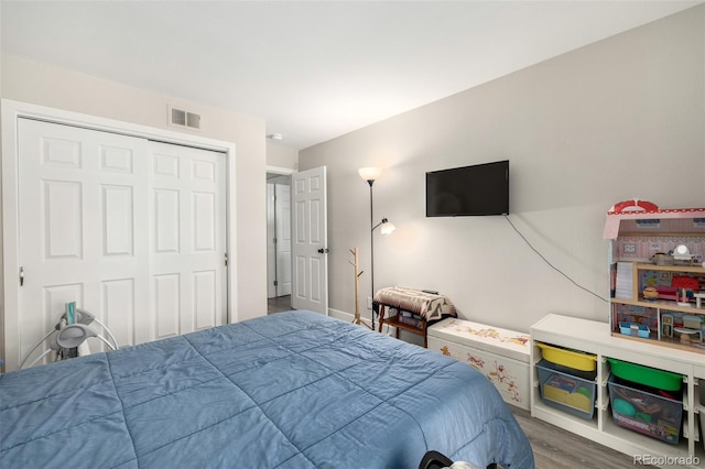 bedroom featuring wood-type flooring and a closet