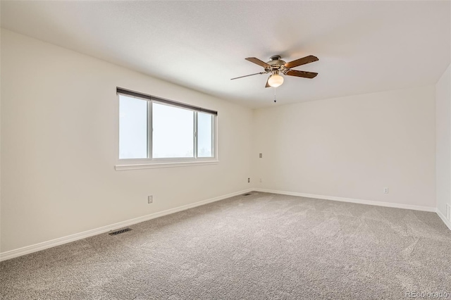 carpeted spare room with ceiling fan