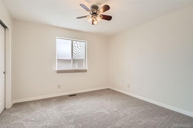 carpeted empty room with ceiling fan