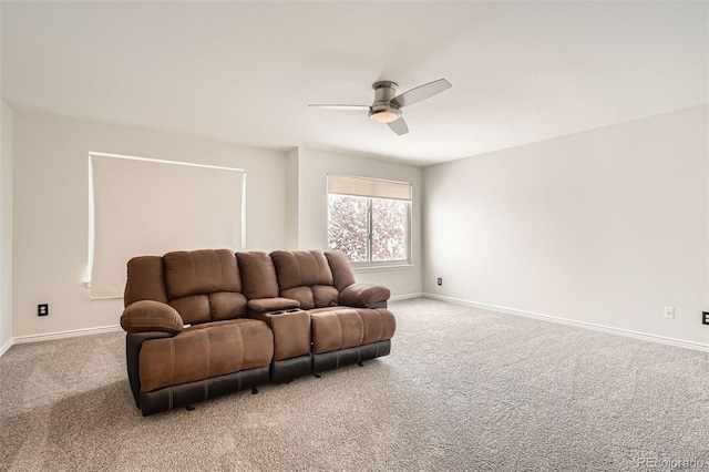 carpeted home theater room with ceiling fan