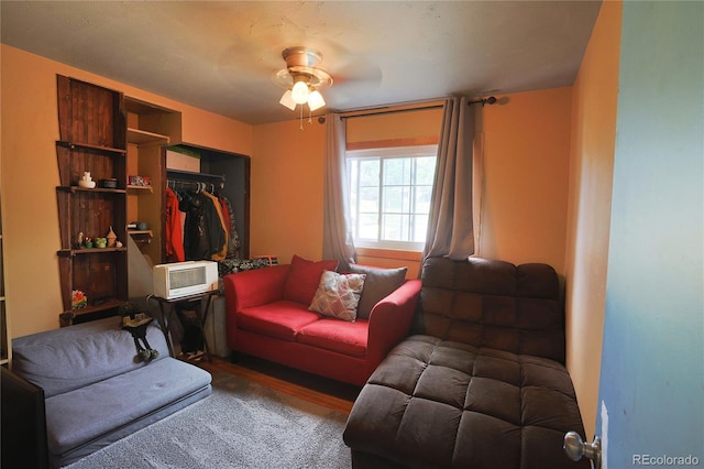 living room with hardwood / wood-style flooring and ceiling fan