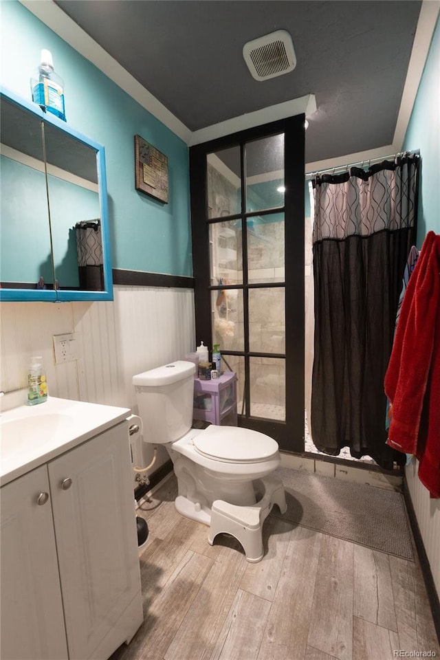 bathroom featuring vanity, toilet, and hardwood / wood-style flooring