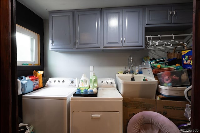 washroom featuring independent washer and dryer and cabinets