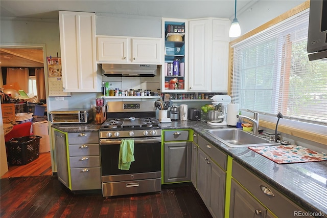 kitchen featuring sink, decorative light fixtures, stainless steel gas range, white cabinetry, and dark hardwood / wood-style flooring