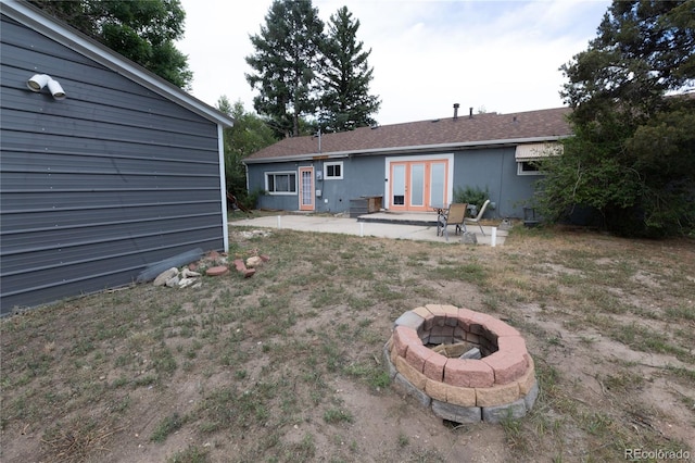 back of house featuring a patio, french doors, and a fire pit