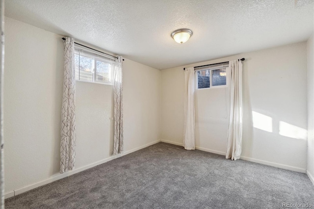 spare room featuring a textured ceiling and carpet floors