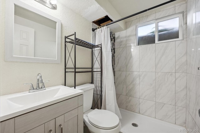 bathroom featuring vanity, curtained shower, and toilet