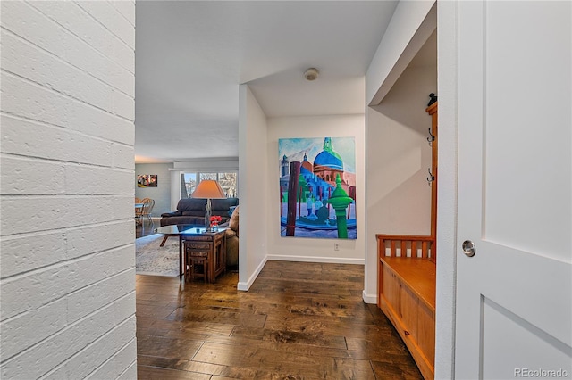 entryway featuring dark wood-style flooring and baseboards