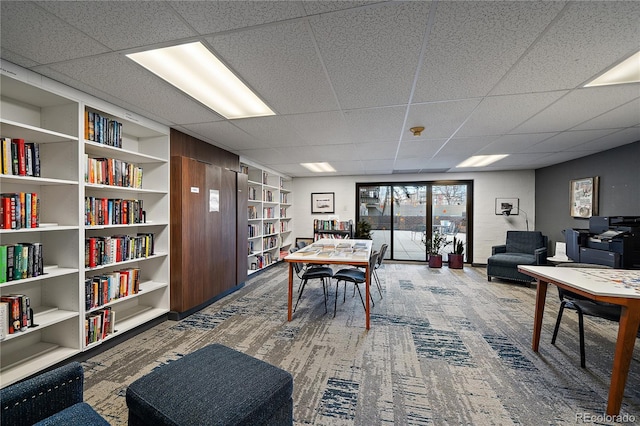 carpeted office space with bookshelves