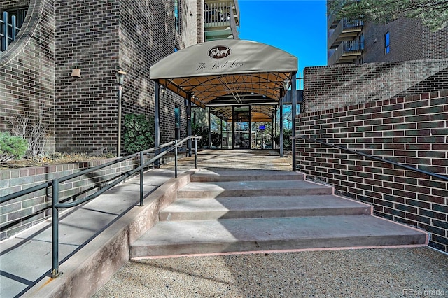 view of exterior entry featuring brick siding