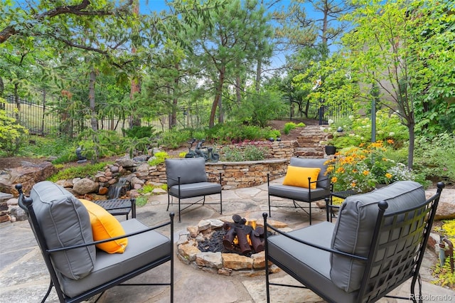 view of patio / terrace with fence and an outdoor fire pit