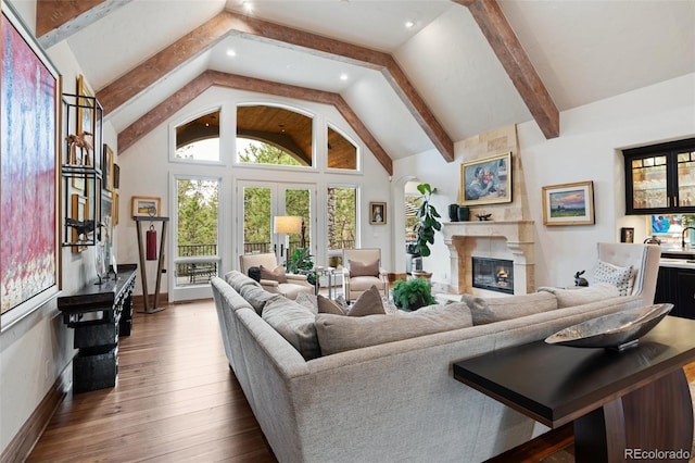 living room featuring a large fireplace, beam ceiling, wood finished floors, baseboards, and recessed lighting