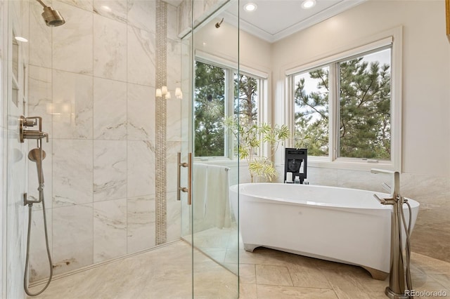 bathroom featuring recessed lighting, ornamental molding, a soaking tub, and a shower stall
