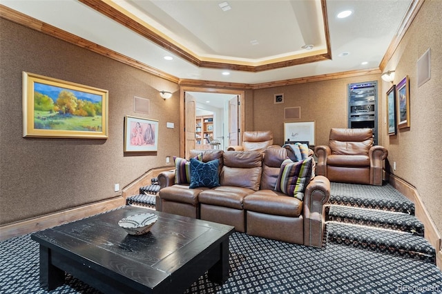 cinema room with crown molding, a raised ceiling, a textured wall, and recessed lighting