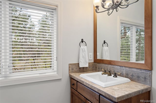bathroom with vanity, tasteful backsplash, and a chandelier