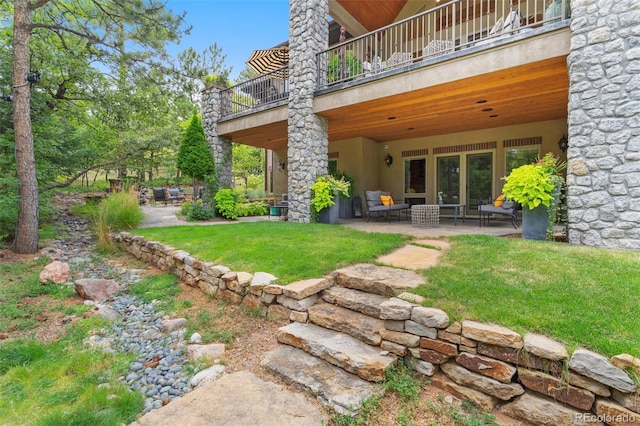 view of yard featuring a patio area and a balcony