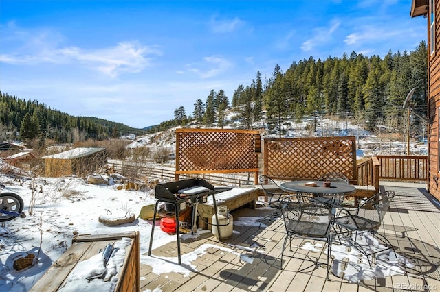 snow covered deck featuring grilling area