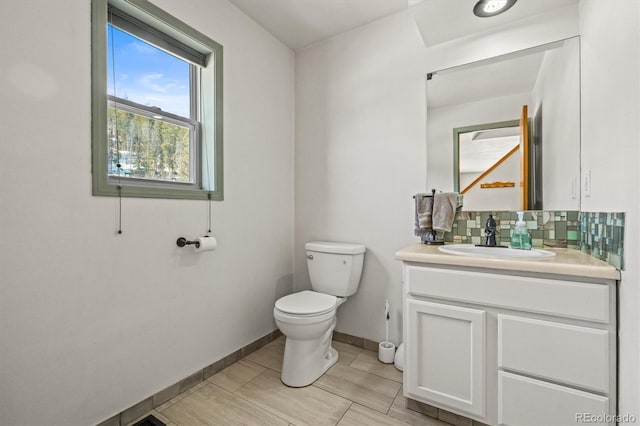 2476 S Beaver Creek Rd, Black Hawk, CO 80422 - half bath featuring toilet, vanity, baseboards, and decorative backsplash