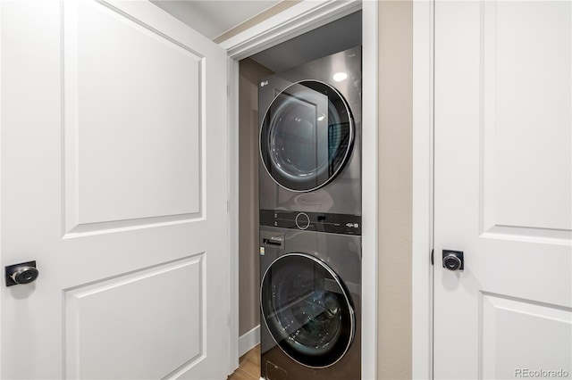 laundry area with stacked washer and dryer