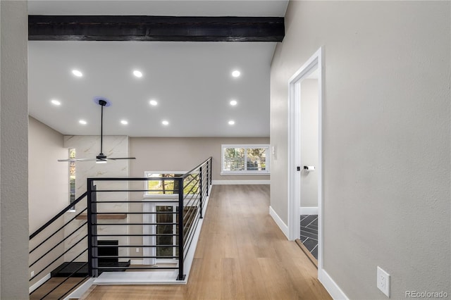 hallway featuring beam ceiling and light hardwood / wood-style floors