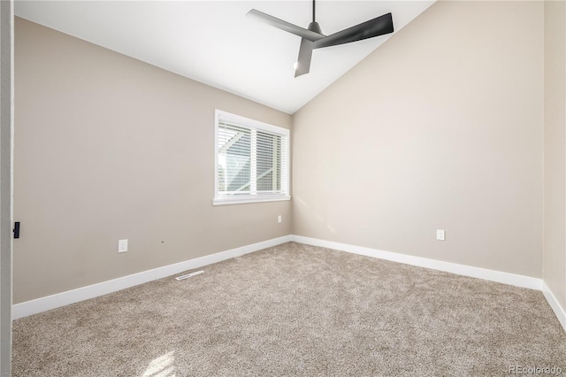 carpeted empty room featuring vaulted ceiling and ceiling fan