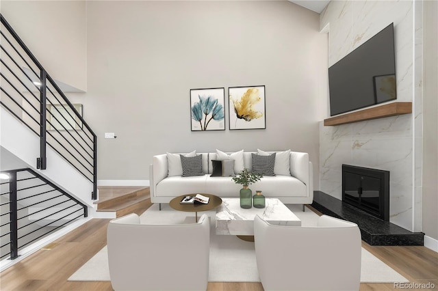 living room with a premium fireplace and light hardwood / wood-style flooring