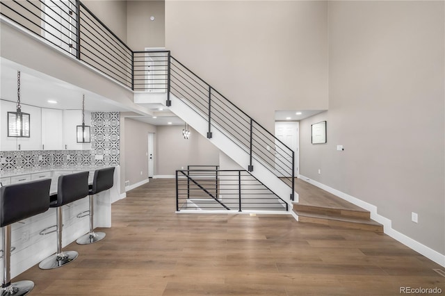 interior space with a high ceiling and hardwood / wood-style flooring