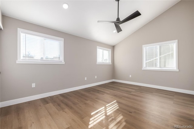 unfurnished room featuring hardwood / wood-style floors, ceiling fan, plenty of natural light, and lofted ceiling