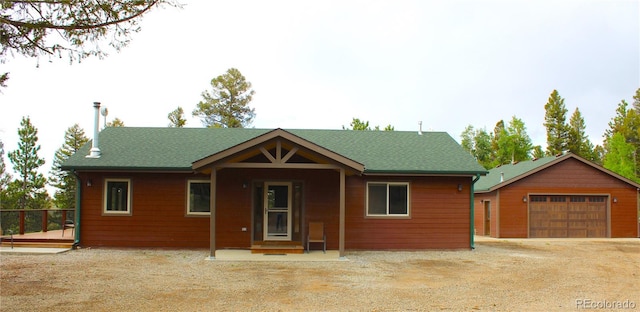 view of front facade featuring a garage and an outdoor structure