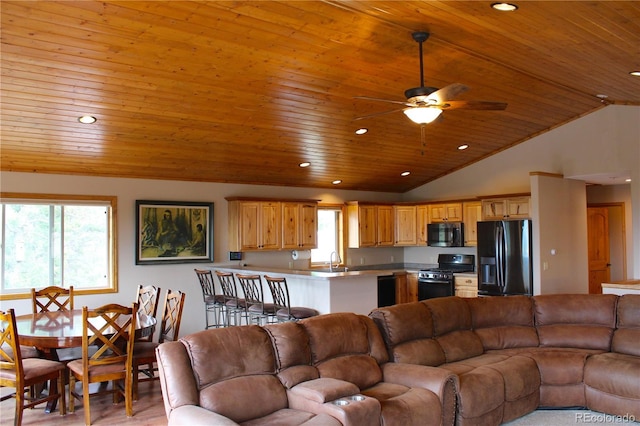 living room with wood ceiling, a healthy amount of sunlight, light hardwood / wood-style flooring, and ceiling fan