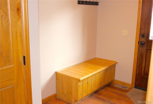 hallway with hardwood / wood-style floors