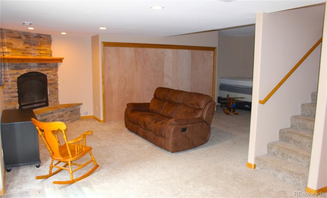 living room featuring light colored carpet and a fireplace