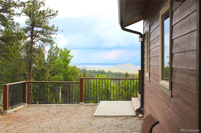 exterior space with a balcony and a mountain view